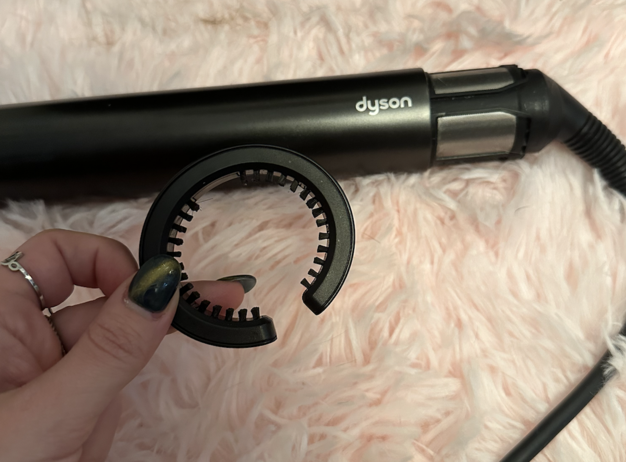 A Dyson Airwrap cleaning brush