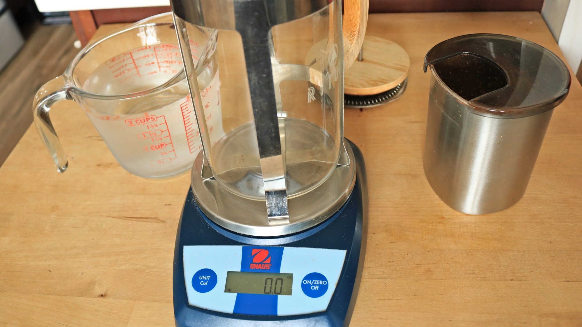 A French press on a kitchen scale.